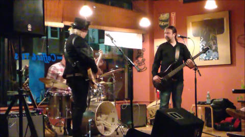 Bex Marshall Band live at Dedham Square Coffee House, Massachusetts. L–R: Nigel Ball (bass), Bex Marshall (vocals/guitar), Alexei Gittens (drums).
