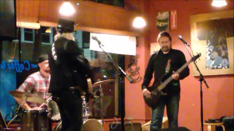 Bex Marshall Band live at Dedham Square Coffee House, Massachusetts. L–R: Nigel Ball (bass), Bex Marshall (vocals/guitar), Alexei Gittens (drums).