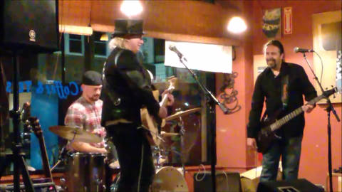 Bex Marshall Band live at Dedham Square Coffee House, Massachusetts. L–R: Nigel Ball (bass), Bex Marshall (guitar/vocals), Alexei Gittens (drums).