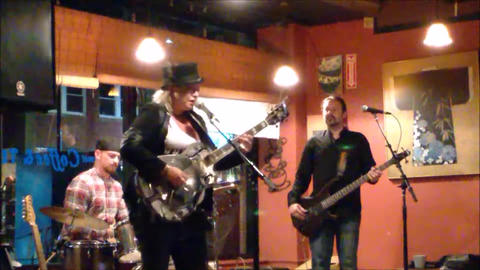 Bex Marshall Band live at Dedham Square Coffee House, Massachusetts. L–R: Nigel Ball (bass), Bex Marshall (guitar/vocals), Alexei Gittens (drums).