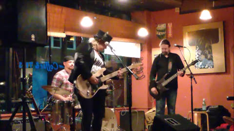 Bex Marshall Band live at Dedham Square Coffee House, Massachusetts. L–R: Nigel Ball (bass), Bex Marshall (vocals/guitar), Alexei Gittens (drums).
