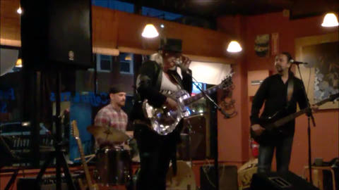 Bex Marshall Band live at Dedham Square Coffee House, Massachusetts. L–R: Nigel Ball (bass), Bex Marshall (guitar/vocals), Alexei Gittens (drums).