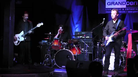 Loz Netto Band live at Grand Central, Worthing. L–R: Nigel Ball (bass), Loz Netto (vocals/guitar), Rob Kenny (drums).